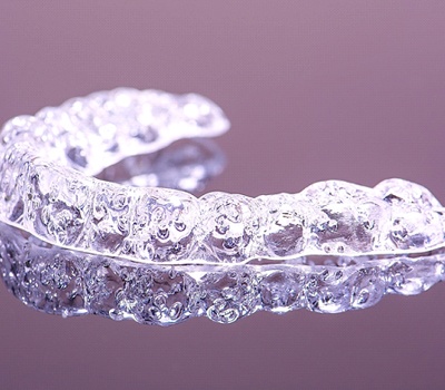 Invisalign clear aligner with purple background