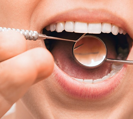 Close up of dental instruments in woman’s mouth