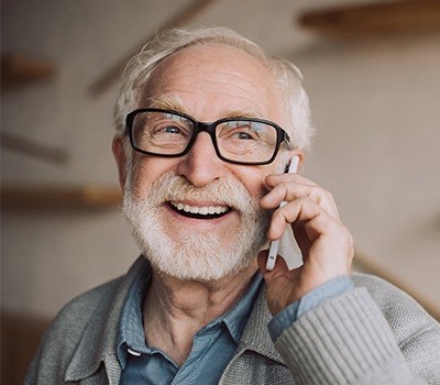 Older man with healthy smile thanks to preventive dentistry