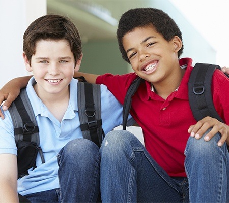 Two boys smiling after children's dentistry appointment