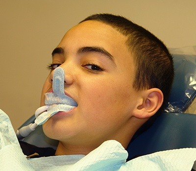 preteen boy getting fluoride treatment