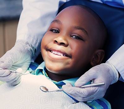 young boy smiling during dental checkup