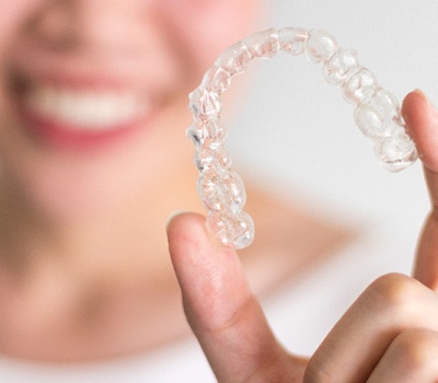 Woman holding a clear aligner