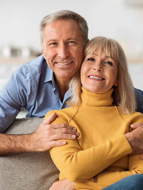 Senior man and woman smiling at home with dentures in Bowie