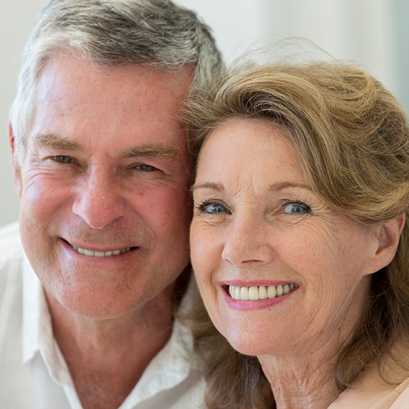 Older man and woman smiling together