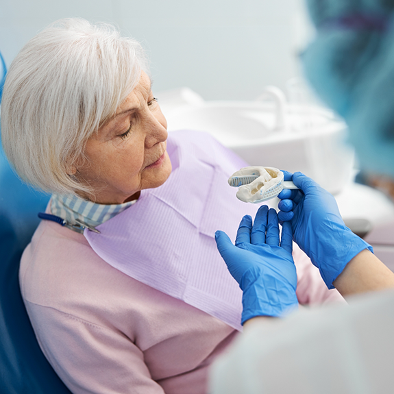 Senior woman in the dental chair being fitted for dentures