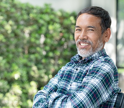 a person smiling and sitting in a chair