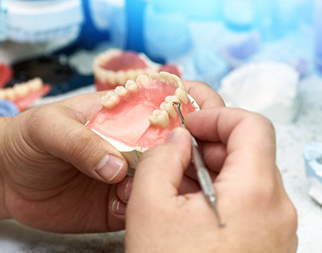 Lab worker adjusting a denture