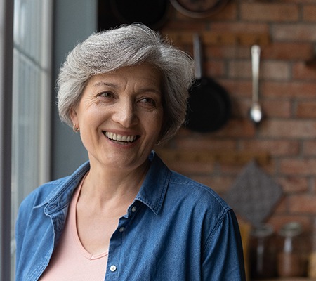 Woman smiling by a window