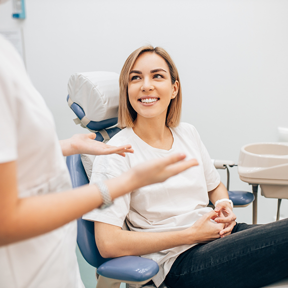 Dental patient smiling at her dentist