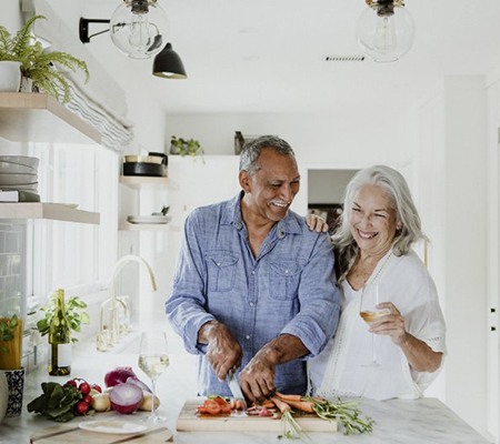 couple cooking together in their kitchen 