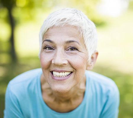 older woman showing off her pearly whites 