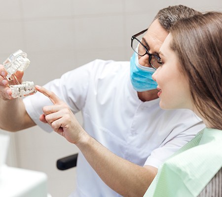 Implant dentist in Bowie explaining dental implant treatment to patient.