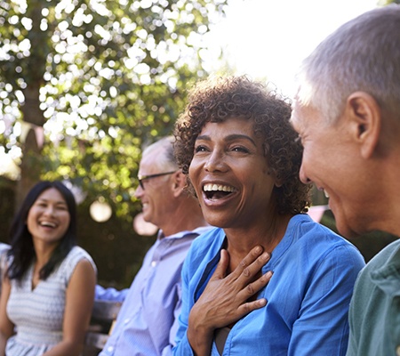 Group of smiling older people with dental implants in Bowie.