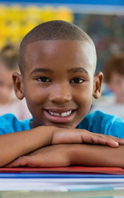 young boy smiling in school