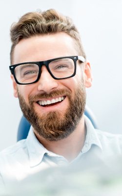 young man smiling in dental chair 