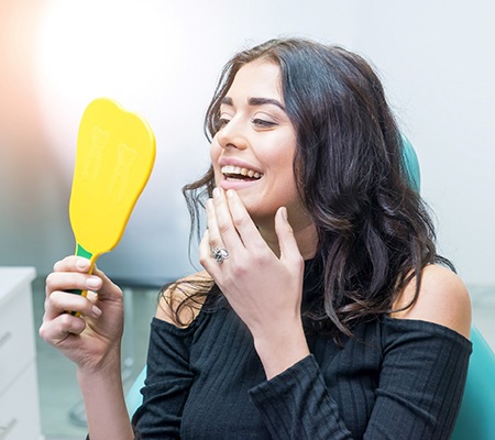 Woman at dentist looking in mirror