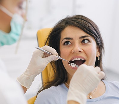 Dentist conducting dental exam on patient