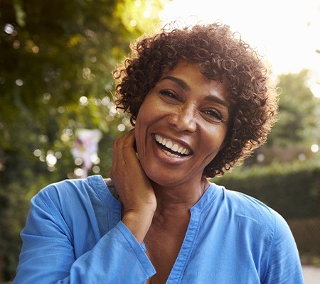 woman smiling in sunshine after root canal therapy