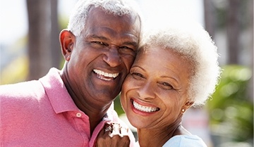 husband and wife sharing healthy smiles after periodontal therapy