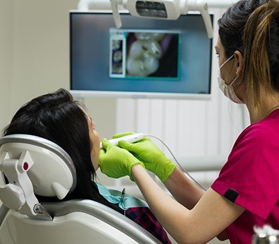 dentist capturing intraoral images during dental checkup