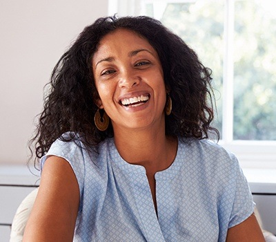 woman with porcelain veneers laughing and smiling
