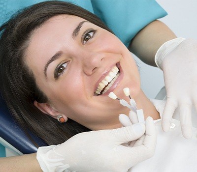 woman's smile compared with porcelain veneer samples