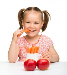 girl with carrots and apples