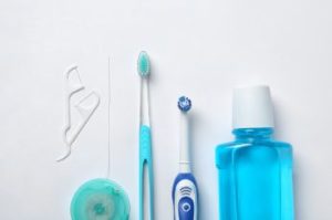 Various oral hygiene tools on white background