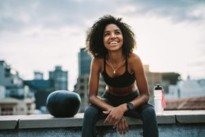 healthy person sitting on a ledge of a building