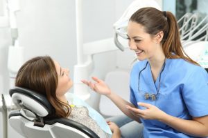 woman talking to her dentist at her dental checkup 