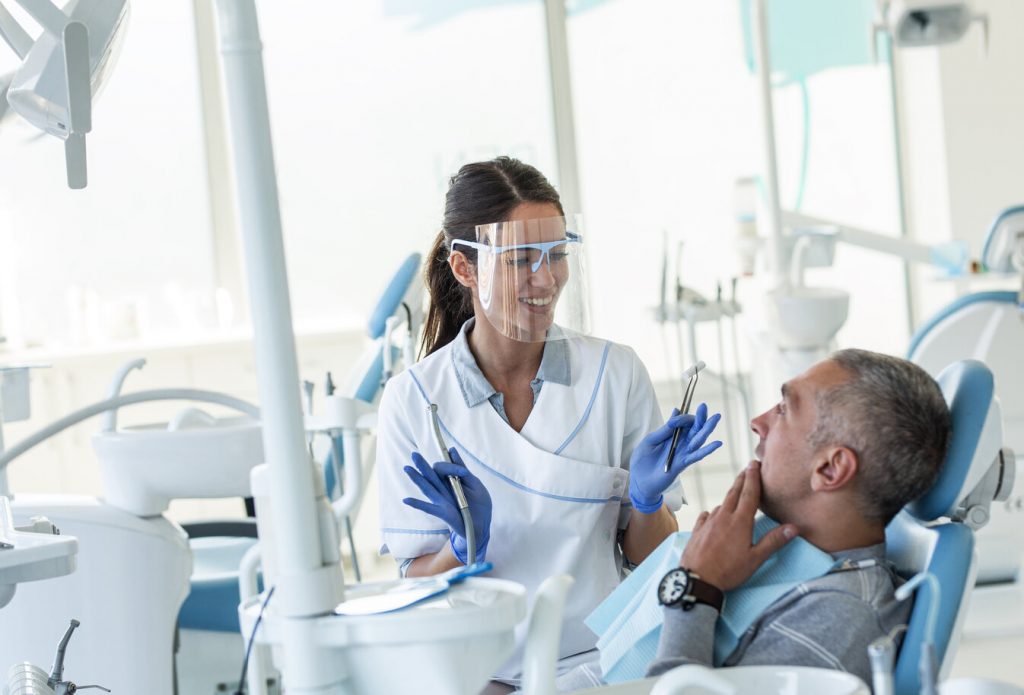 patient learning about the difference between Invisalign and veneers