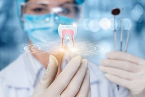 a dentist holding an image of an infected tooth needing root canal therapy