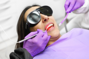 Patient receiving a teeth whitening at her dentist’s office