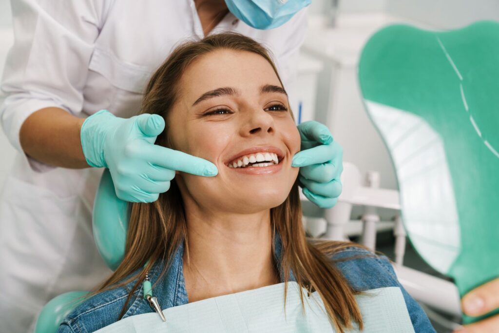 A woman smiling at the dentist